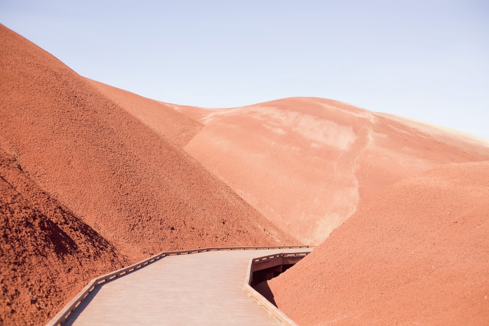 brown and white concrete house on brown sand