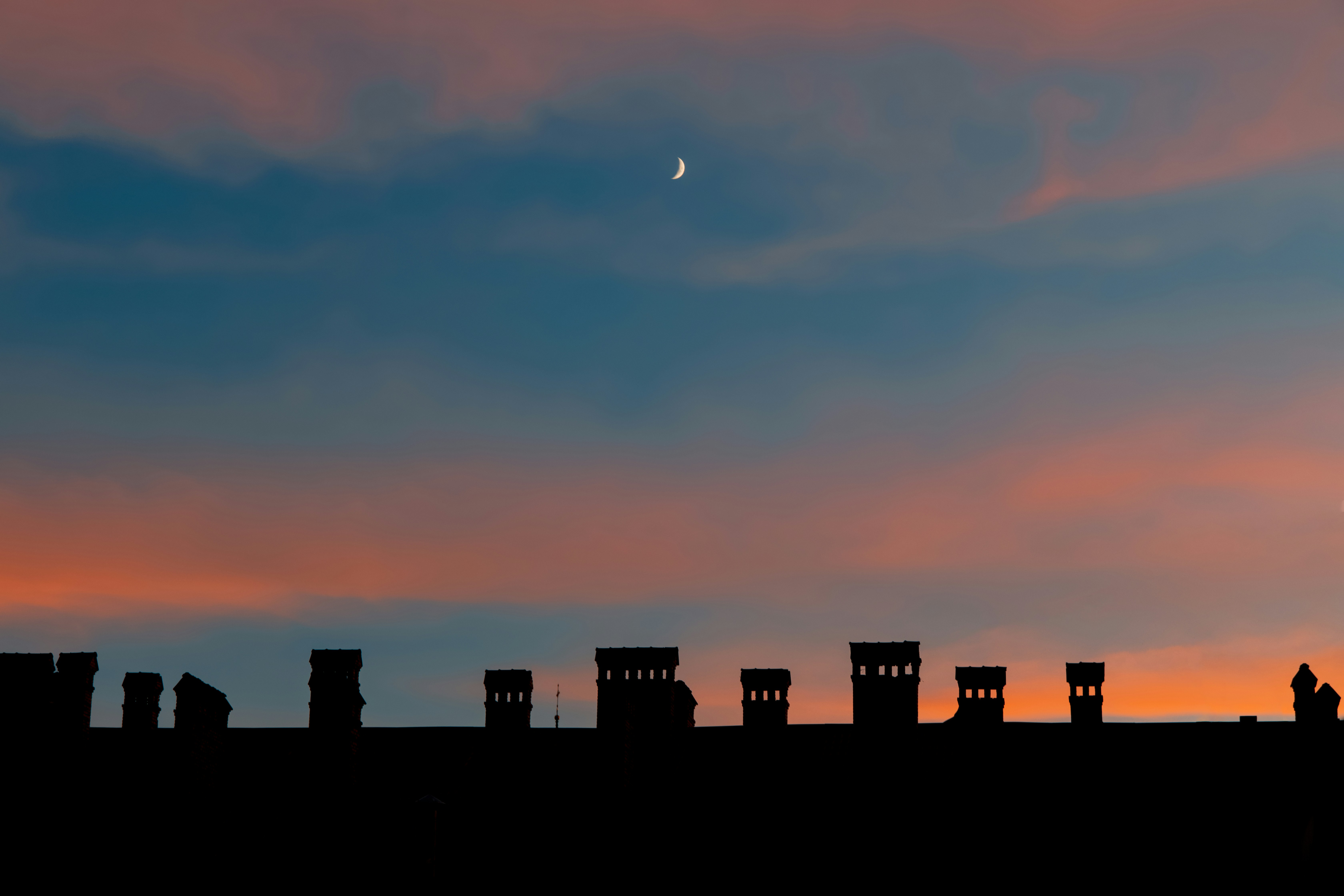 silhouette of city buildings during sunset