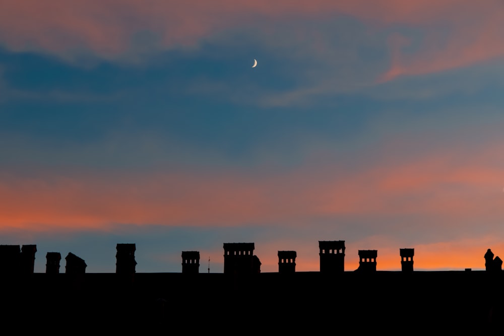 silhouette of city buildings during sunset