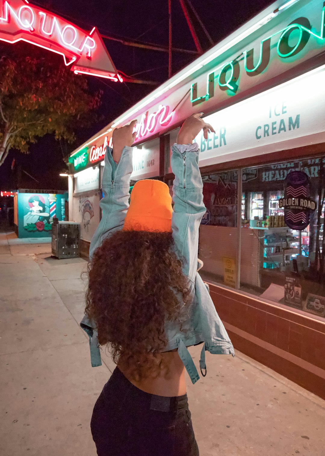 woman in white and black dress standing on sidewalk during nighttime