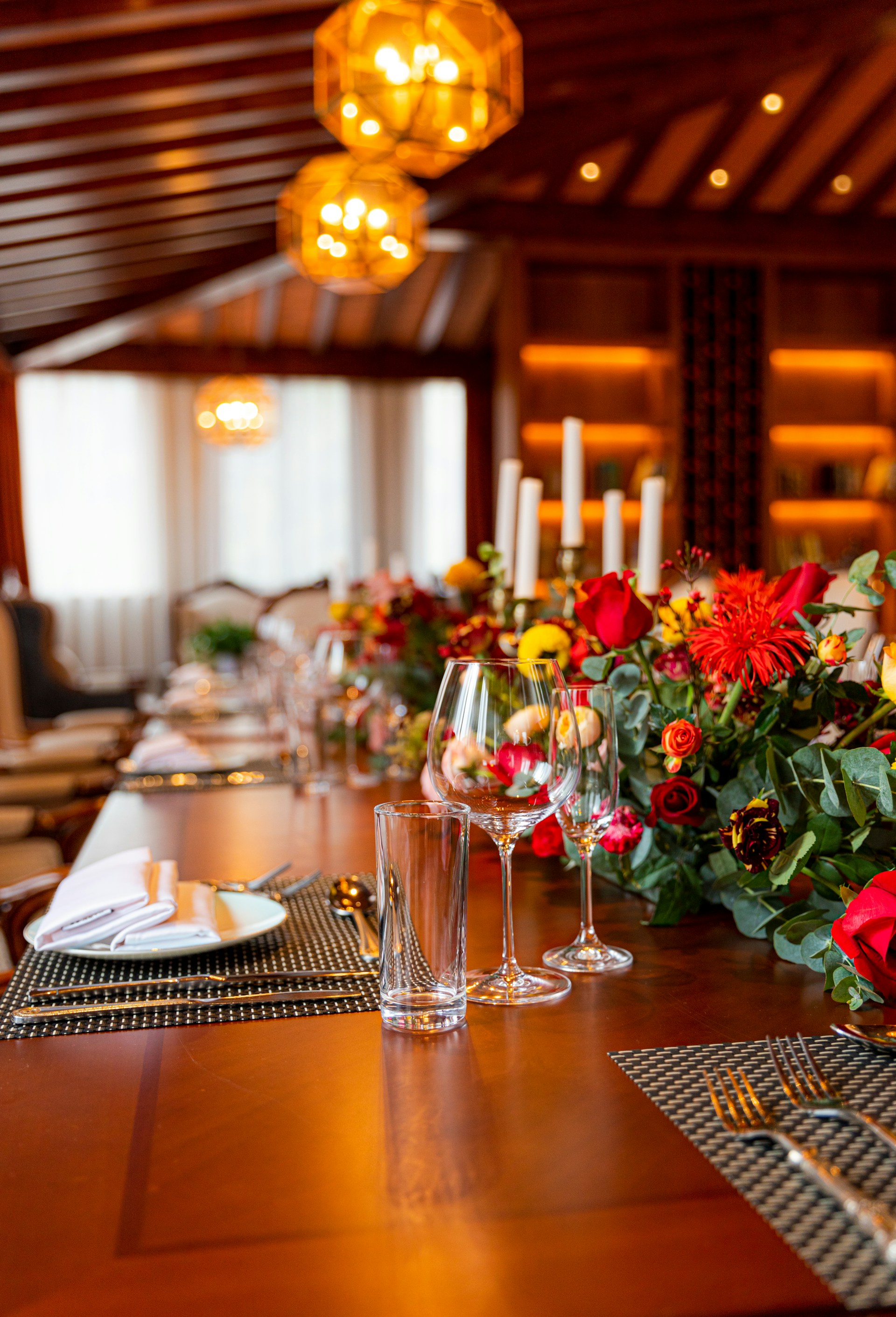 An elegant table setting featuring natural textures and warm tones, with delicate floral arrangements in a bright room.