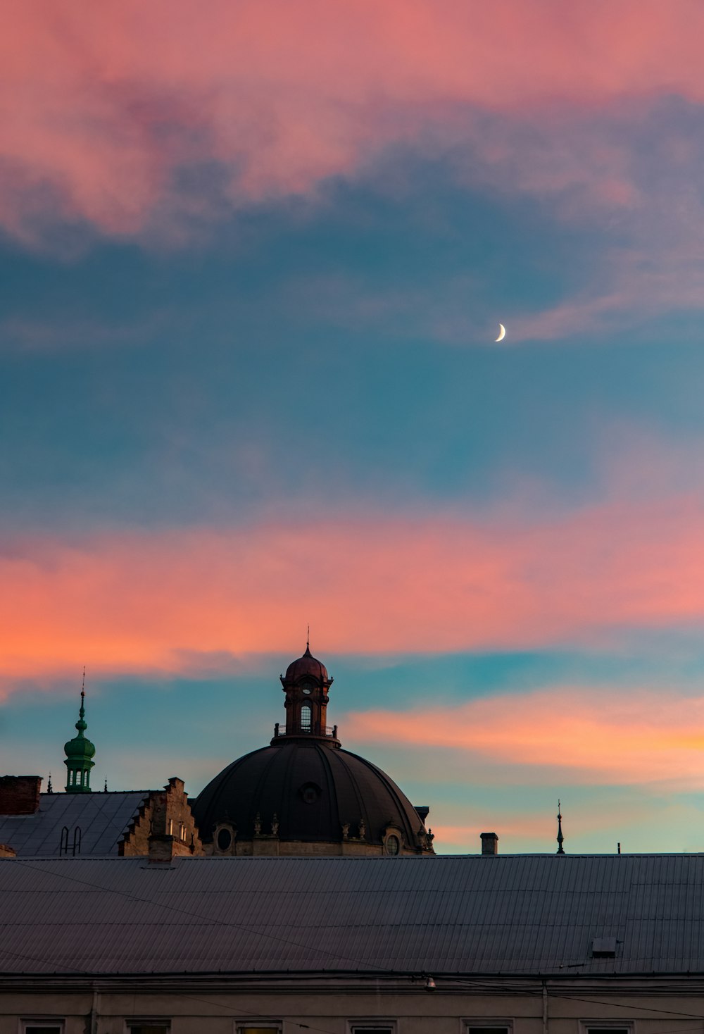 black and white dome building under orange sky