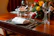 A warmly lit dining table set for an intimate family dinner with elegant plates and fresh flowers.