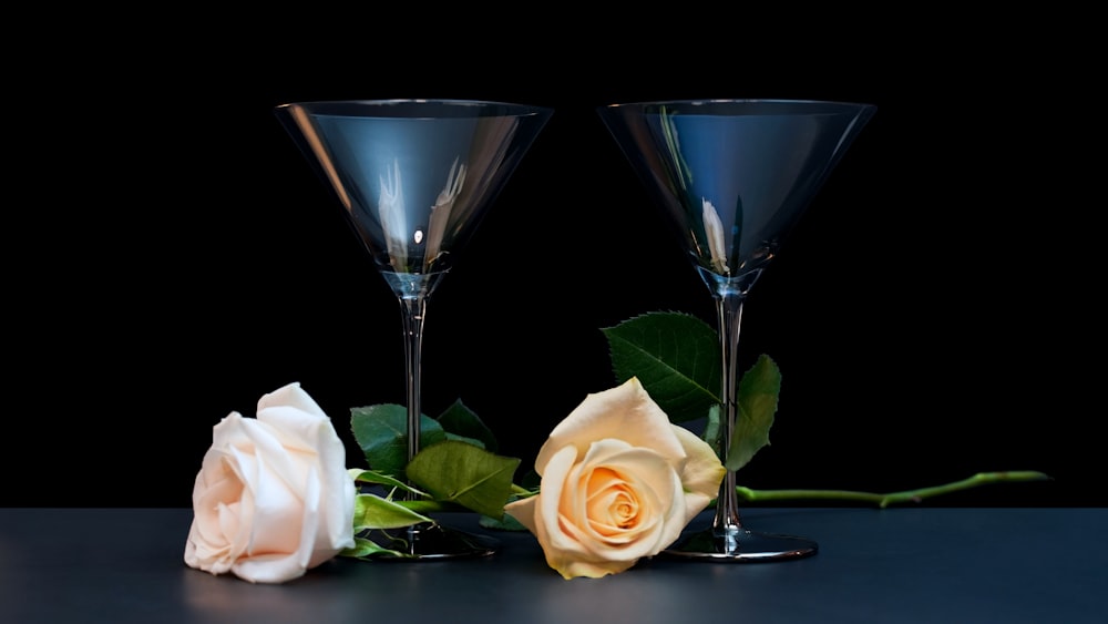 white rose beside clear wine glass