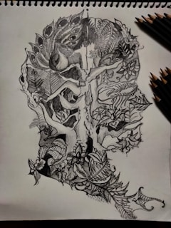 A delicate fine-line tattoo design featuring mystical nature elements in black and white.