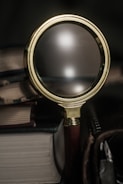 A close-up of a magnifying glass over documents.