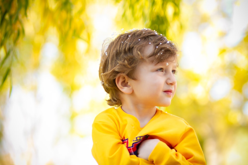 girl in yellow hoodie standing during daytime