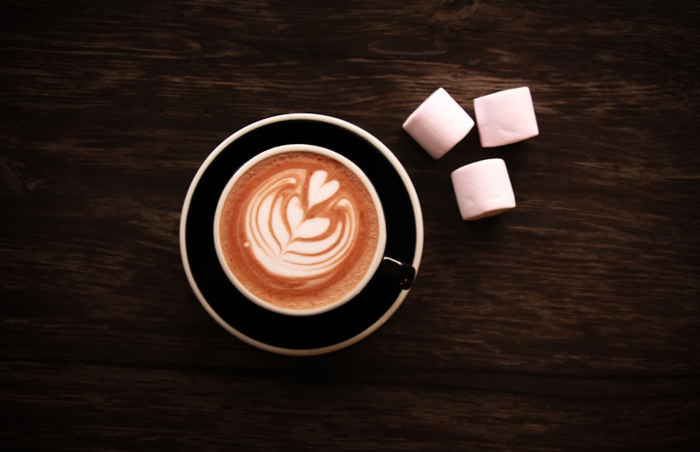 black ceramic mug with cappuccino