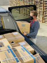 woman in black and white striped long sleeve shirt sitting on black car