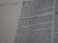 Text from a printed page that includes sections of highlighted text and a heading. The text appears in a typical column layout found in books or documents. Beside the text are lined sections for notes or annotations.