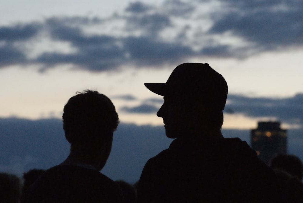 silhouette of man wearing cowboy hat during sunset