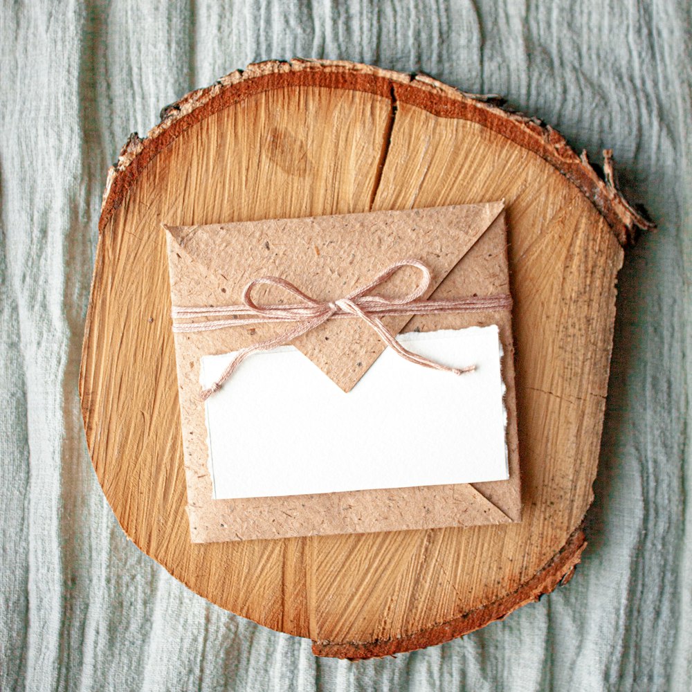 white paper on brown wooden heart shape board