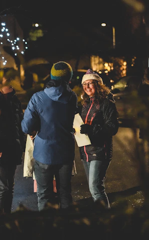 Staff and residents sharing smiles during a festive celebration outdoors.