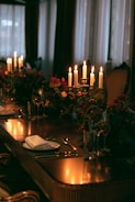 An elegant banquet setup with candles and table settings.