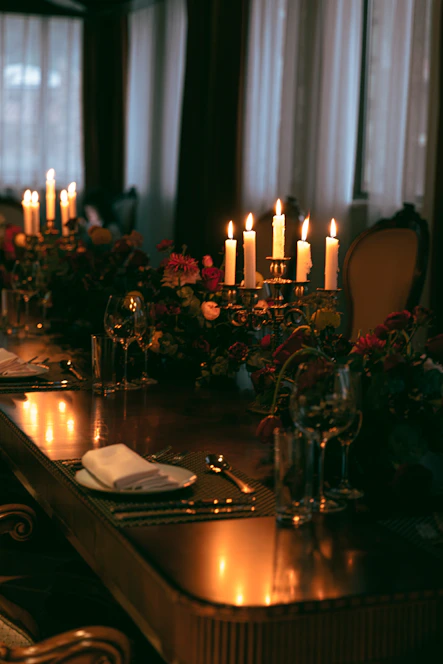 An elegantly set dining table featuring ornate silverware, candlelight, and vintage decor evoking a 1920s Parisian soirée.