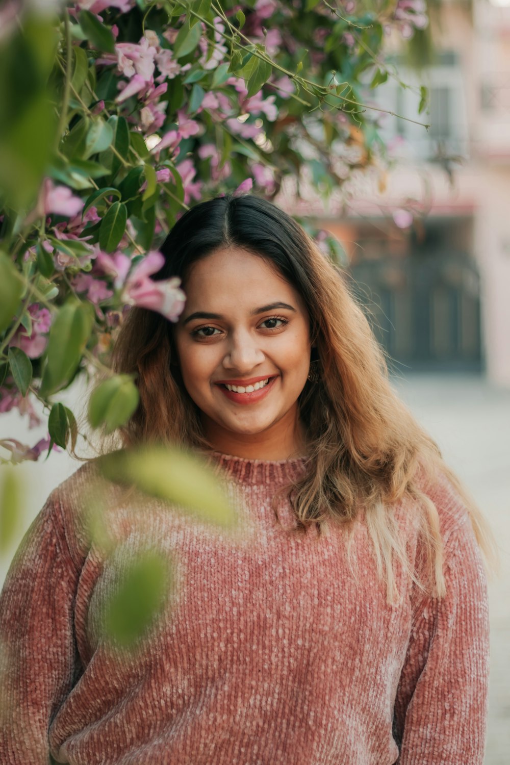 woman in pink knit sweater smiling