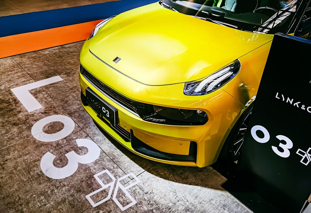 yellow porsche 911 on black and white floor