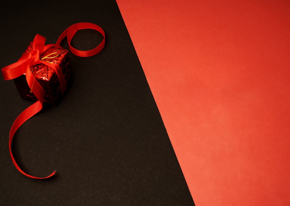 red and black plastic toy on black table