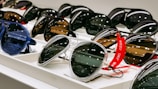 black framed sunglasses on white table