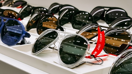 black framed sunglasses on white table