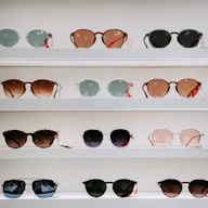 black framed sunglasses on white surface