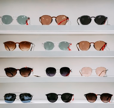 black framed sunglasses on white surface