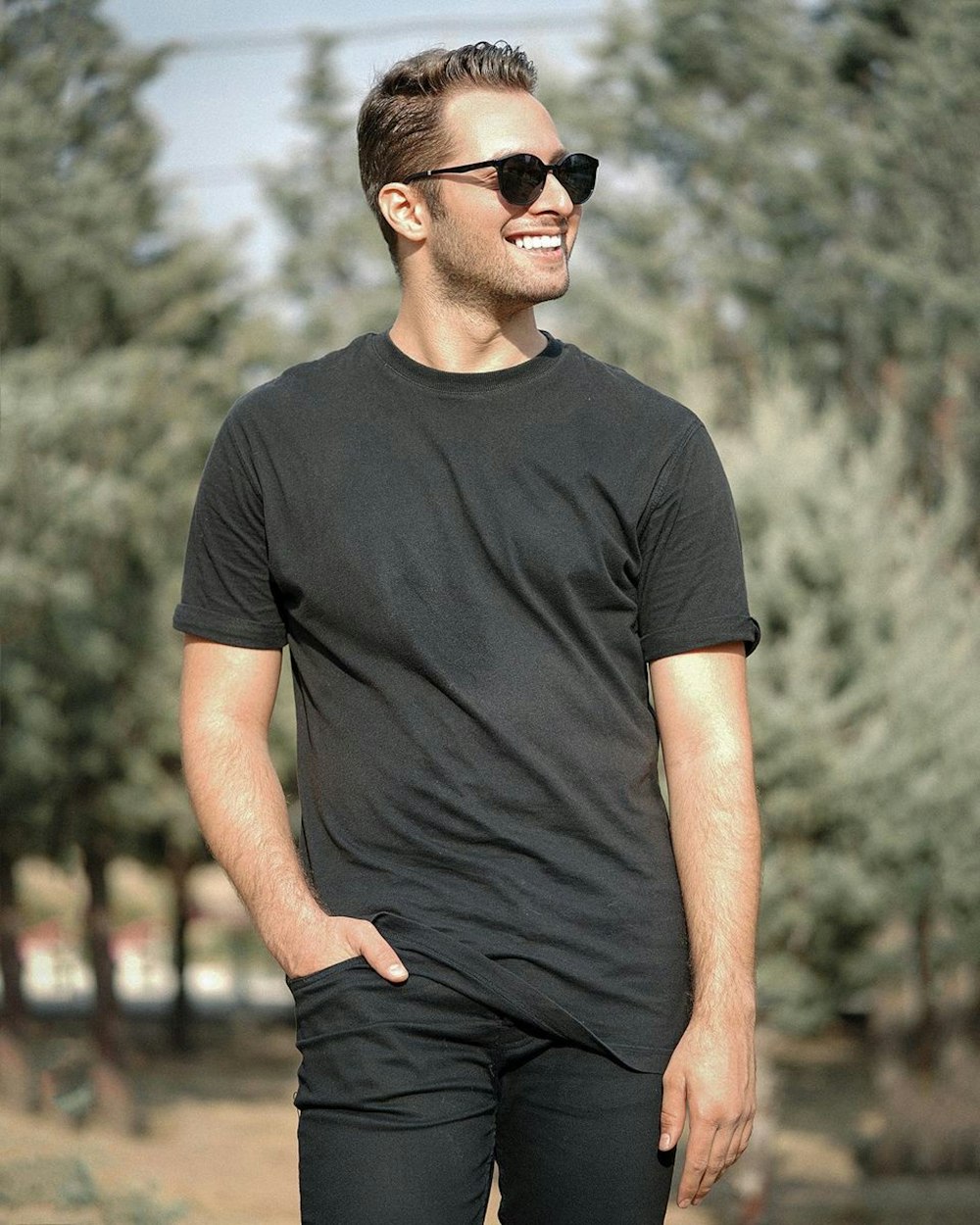 man in black crew neck t-shirt and black sunglasses