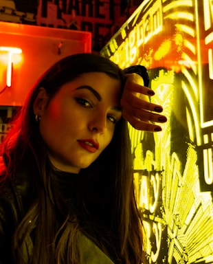 A neon-lit cyberpunk style close-up of a confident blonde woman in a leather outfit, inviting contact.