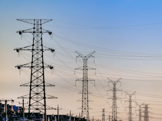 black electric post under blue sky during daytime