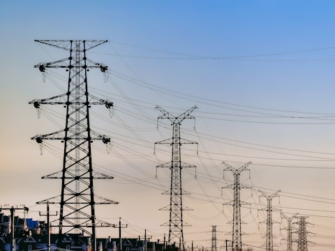 black electric post under blue sky during daytime
