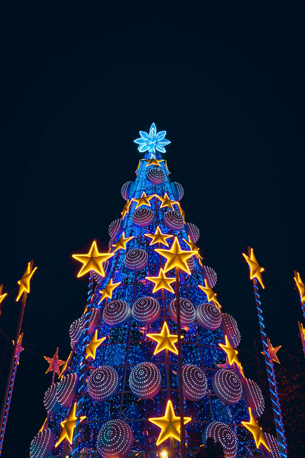 blue and red christmas tree with string lights