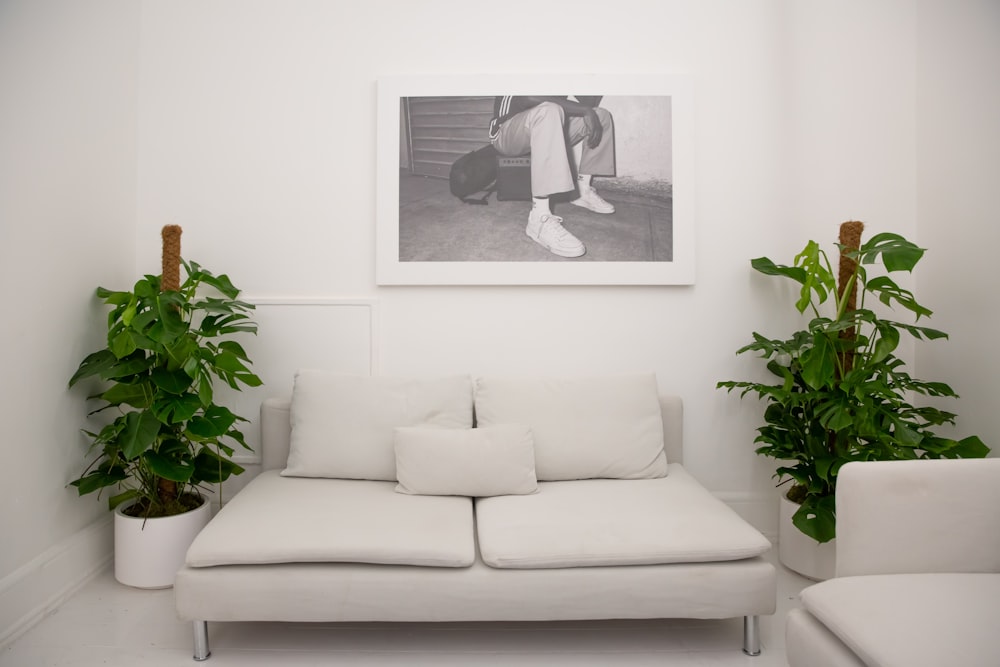 white 2 seat sofa with throw pillows