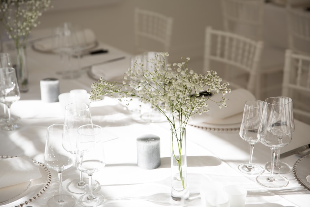 white flowers in clear glass vase on table