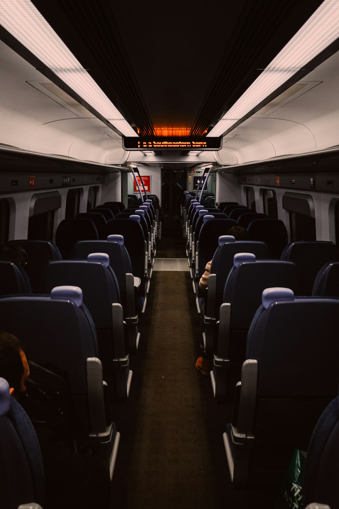 people sitting on blue and black seats
