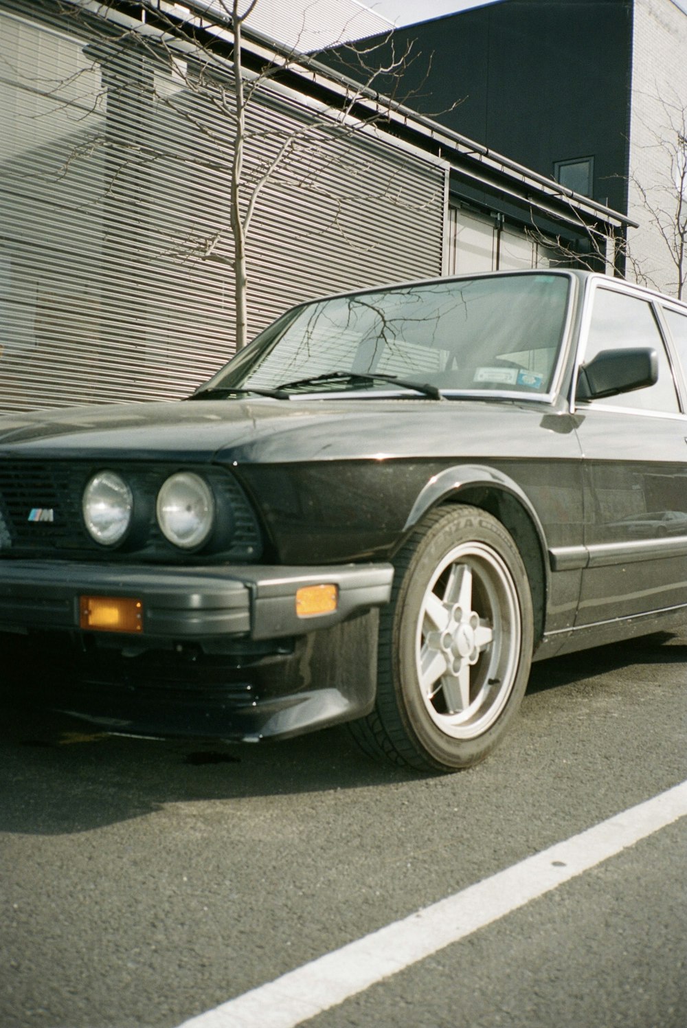 silver mercedes benz coupe parked on gray asphalt road during daytime