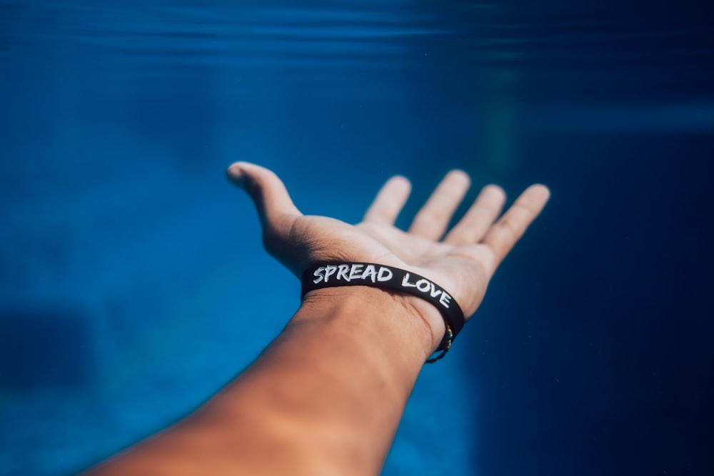 person wearing black silicone bracelet
