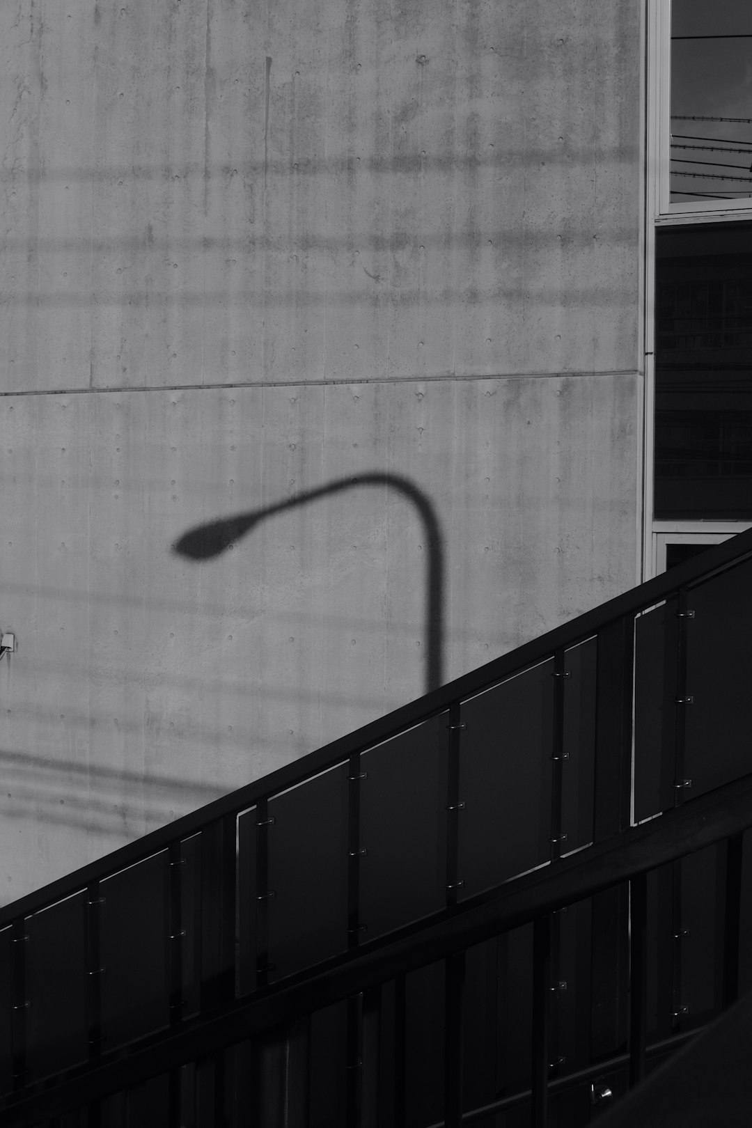 black metal railings near white wall