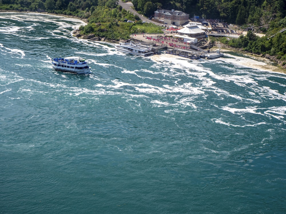 blue and white boat on water during daytime