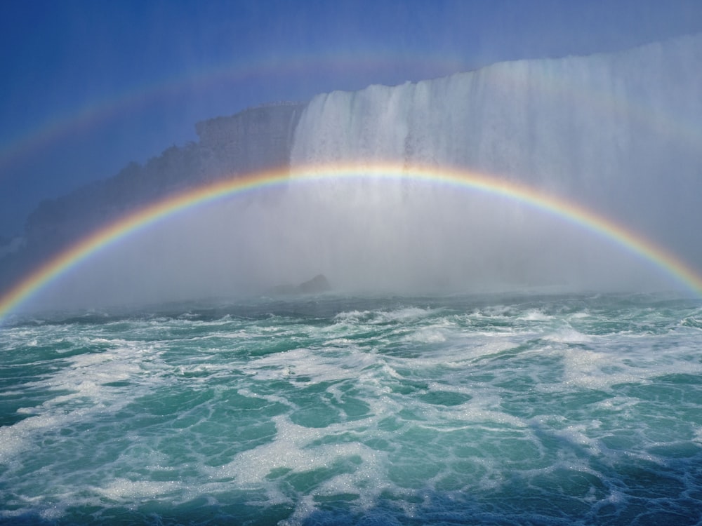 rainbow over the ocean during daytime