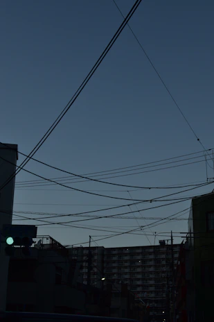 A city skyline at dusk with visible digital connection lines overlay.