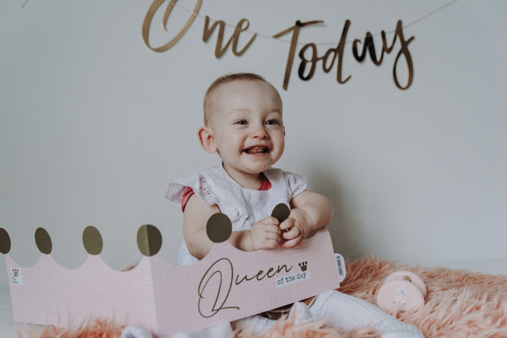 baby in white shirt on bed