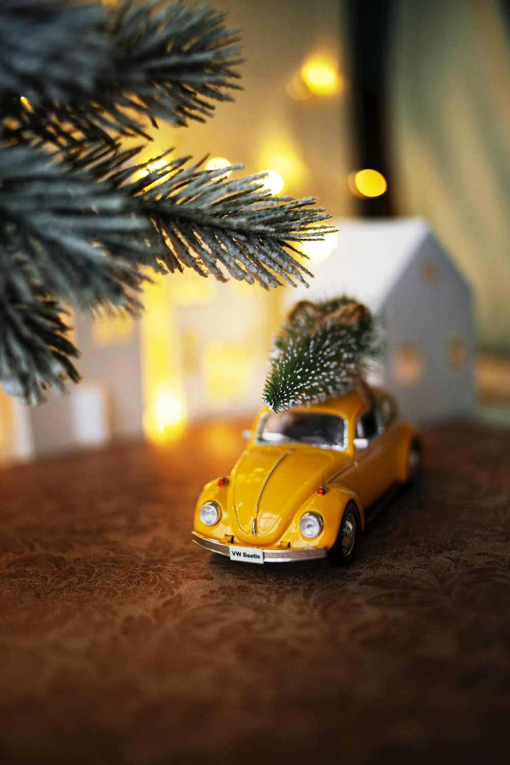yellow volkswagen beetle parked beside green palm tree during daytime