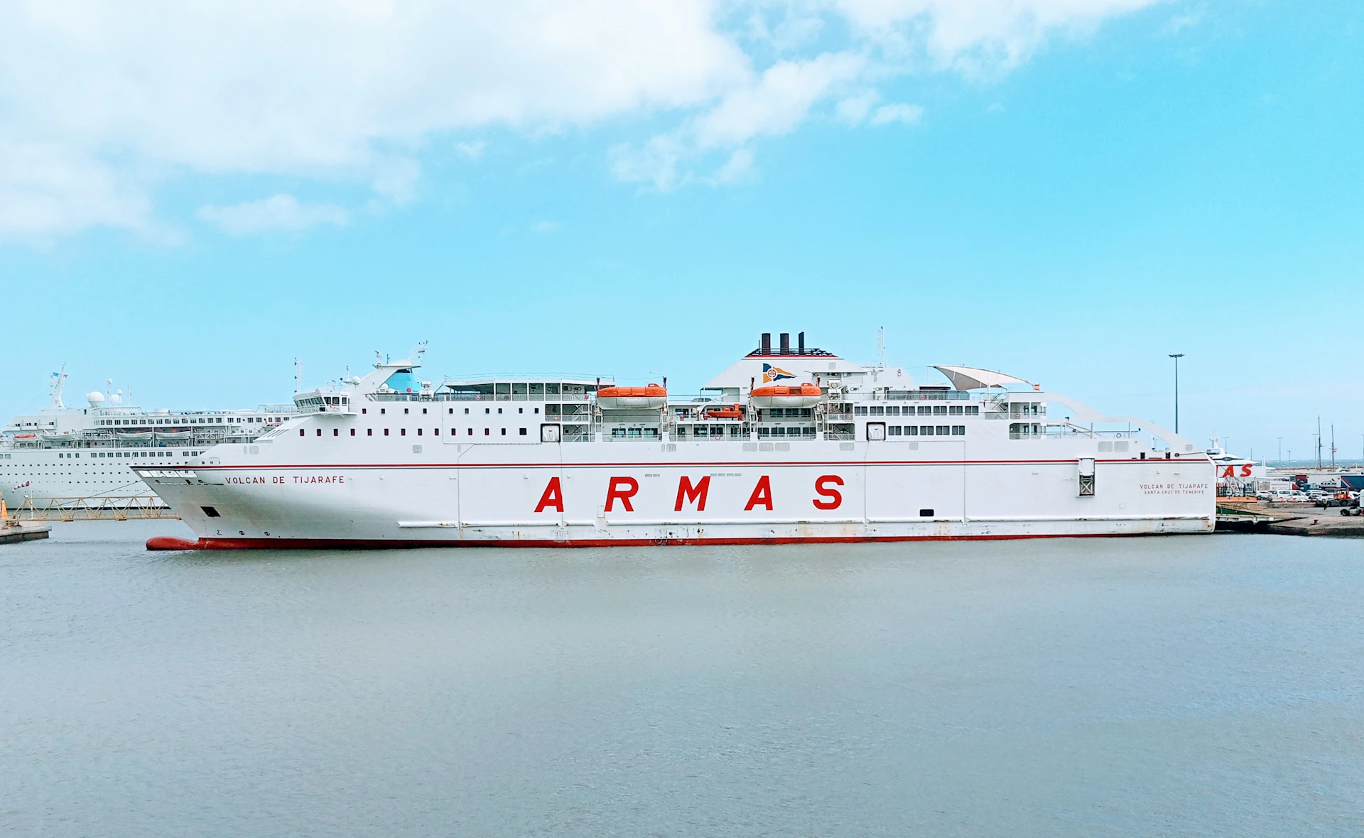 white and red ship on sea under blue sky during daytime