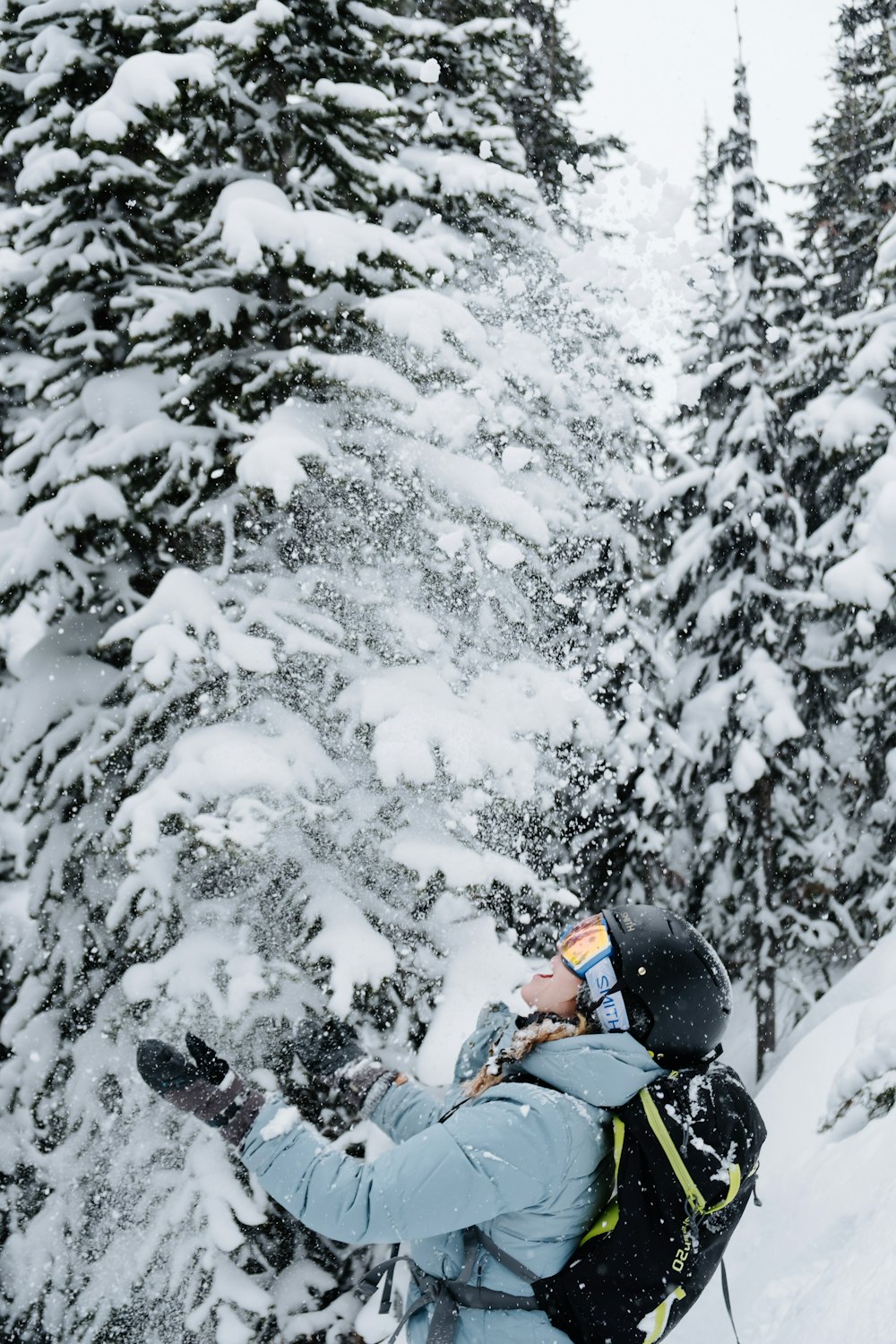 person in red jacket riding on snow sled on snow covered ground during daytime