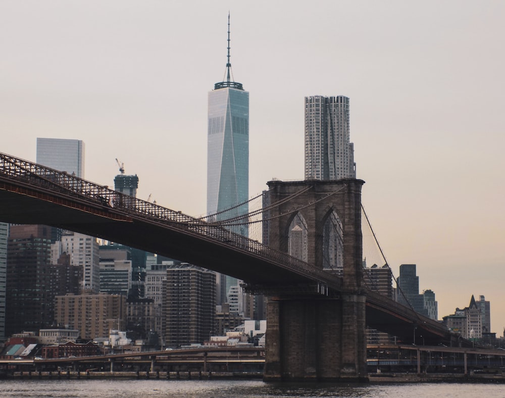 brown bridge over city skyline during daytime