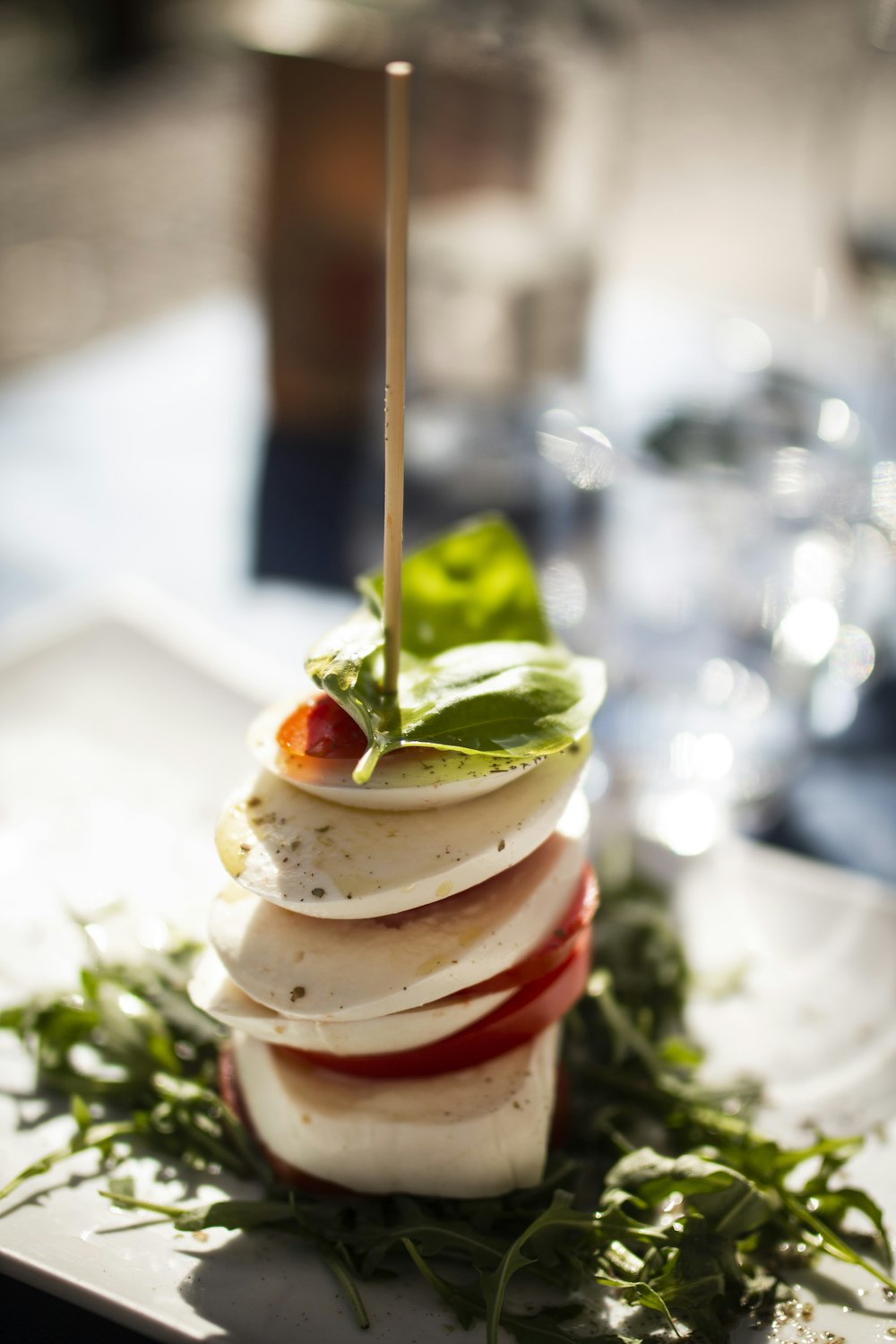 sliced of strawberry and green leaf vegetable on white ceramic plate