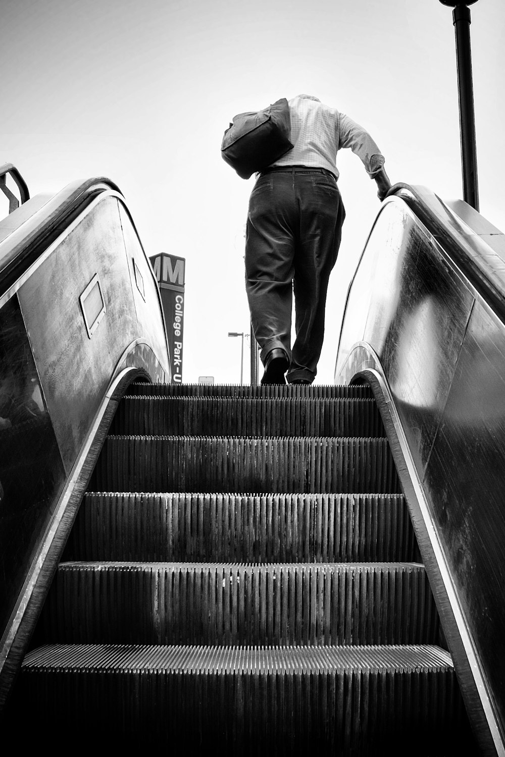 man in black jacket and pants walking down the stairs