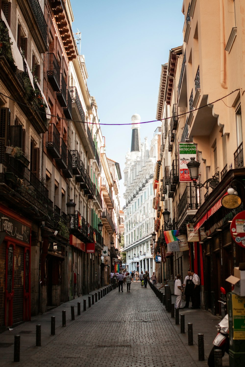 people walking on street between buildings during daytime