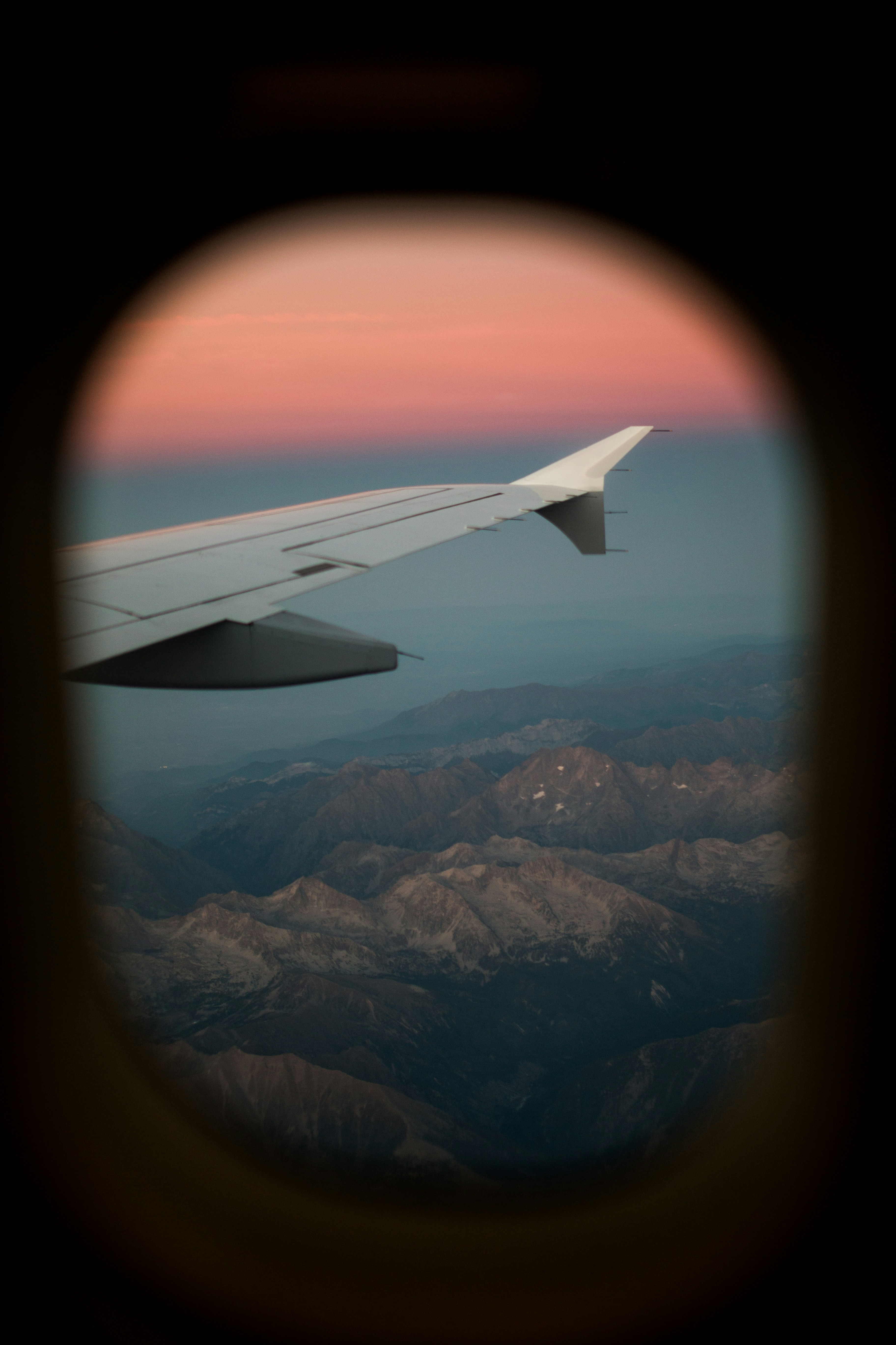airplane window view of mountains during daytime