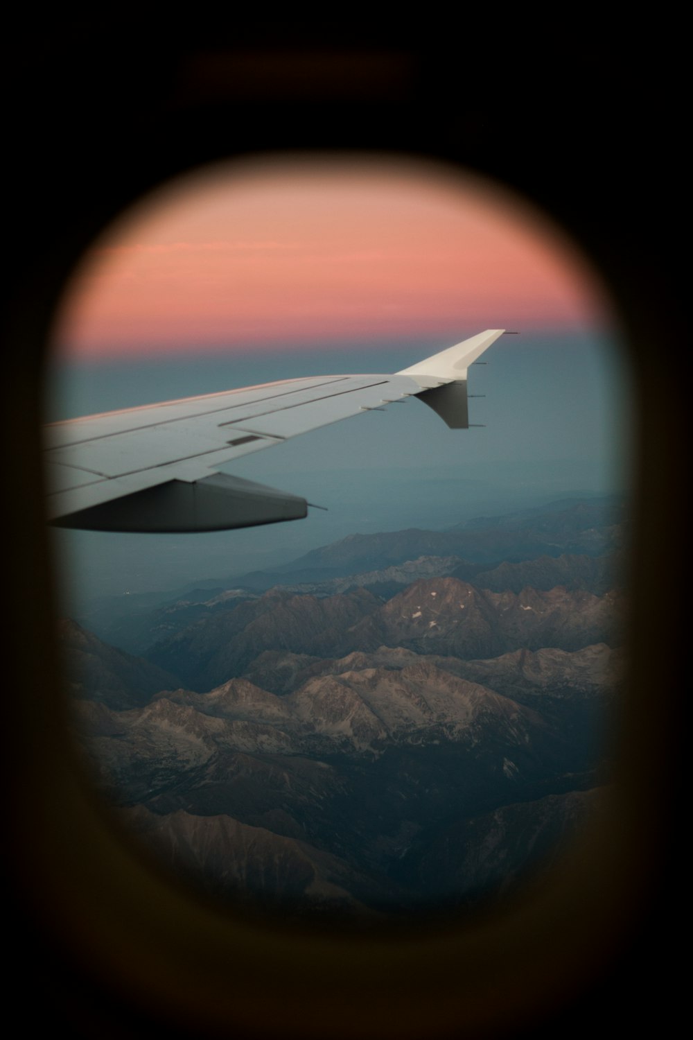 airplane window view of mountains during daytime